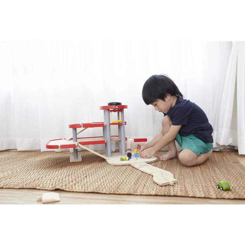 Kid playing PlanToys Parking Garage