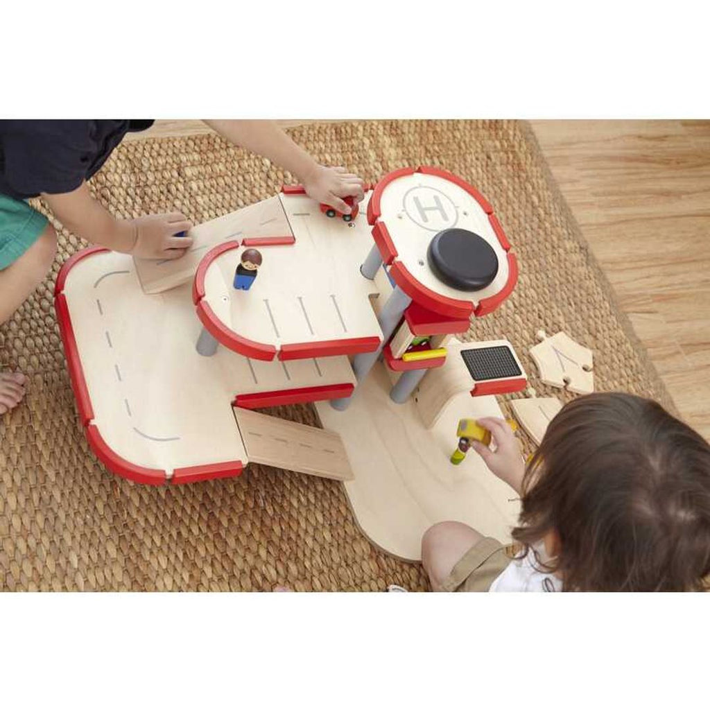 Kid playing PlanToys Parking Garage