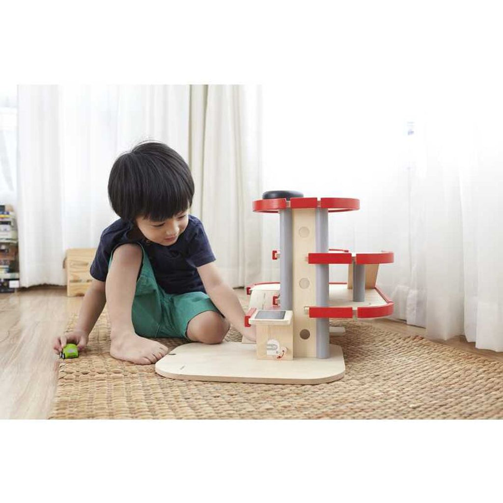 Kid playing PlanToys Parking Garage