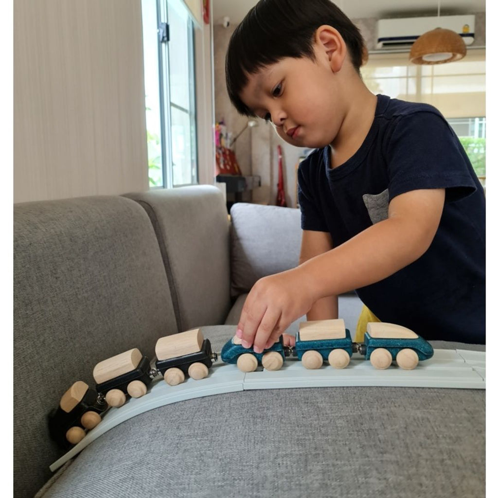 Kid playing PlanToys Classic Train