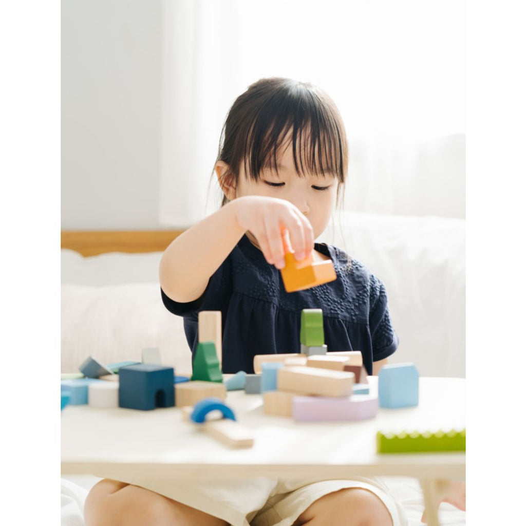 Kid playing PlanToys Urban City Blocks