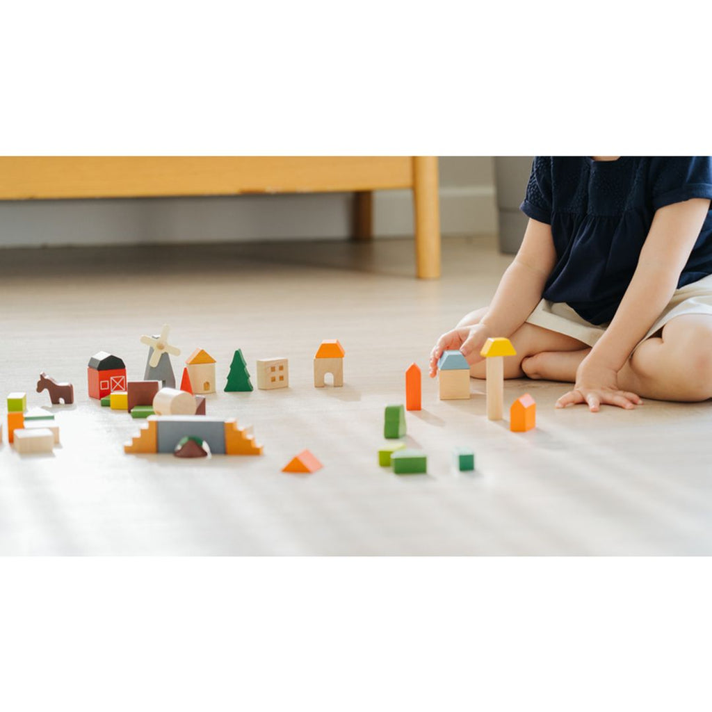 Kid playing PlanToys Countryside Blocks