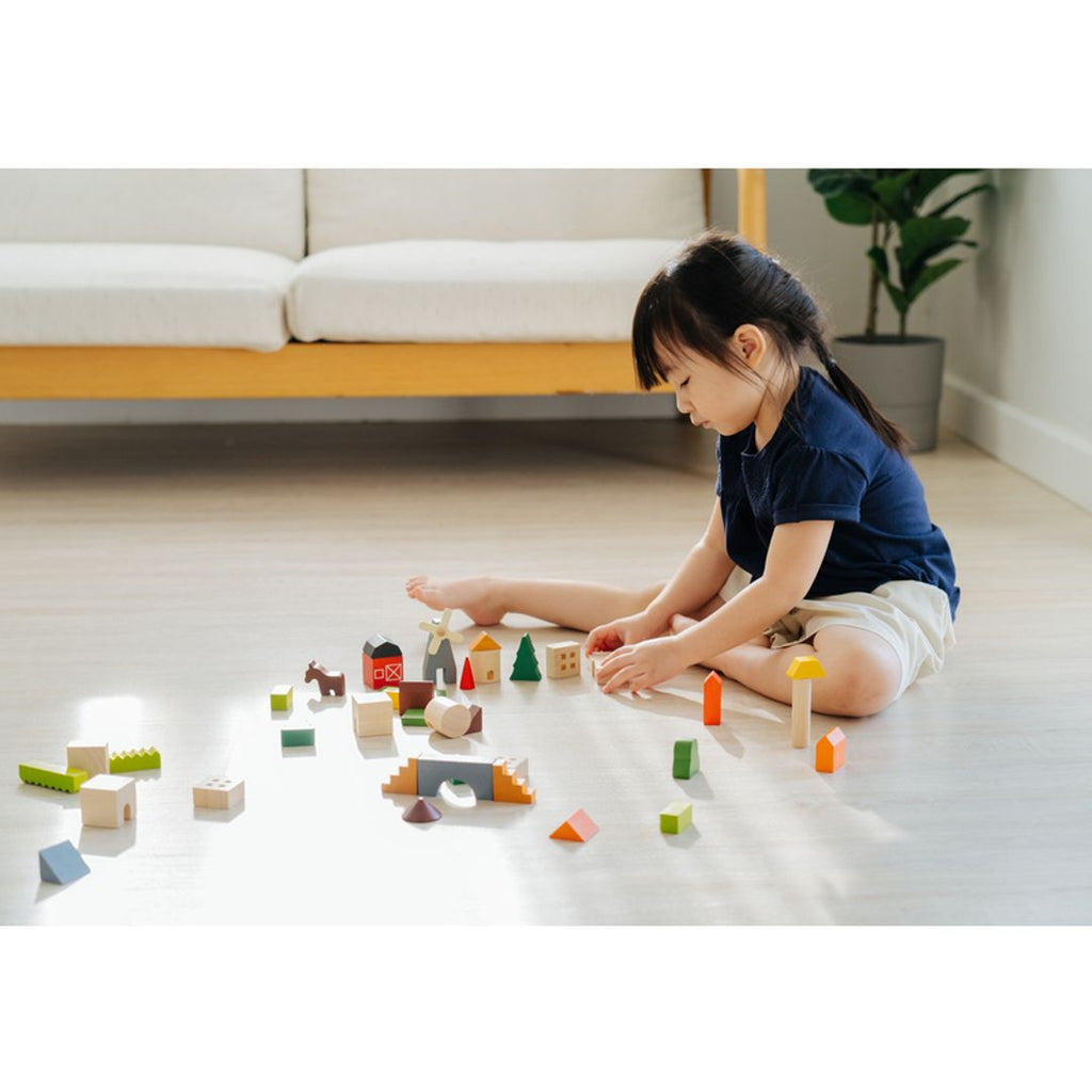 Kid playing PlanToys Countryside Blocks