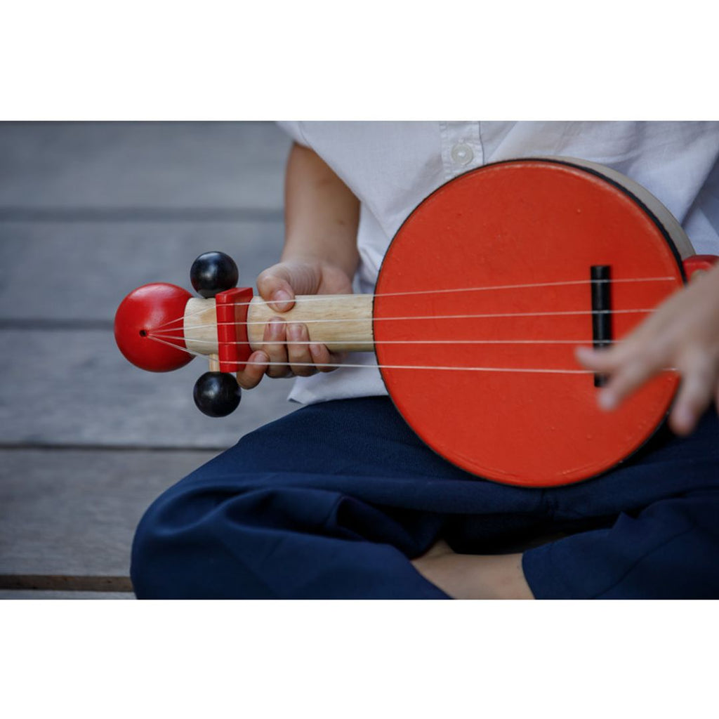 Kid playing PlanToys Banjo