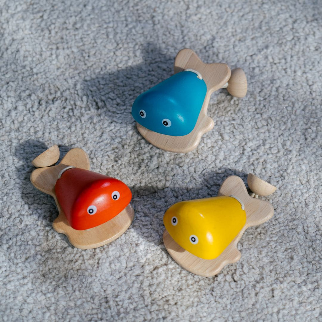 Kid playing PlanToys Fish Castanet