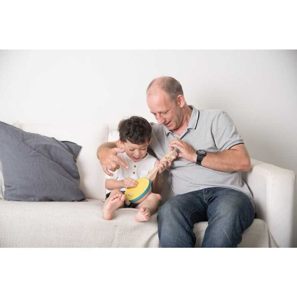 Kid playing PlanToys Banjolele