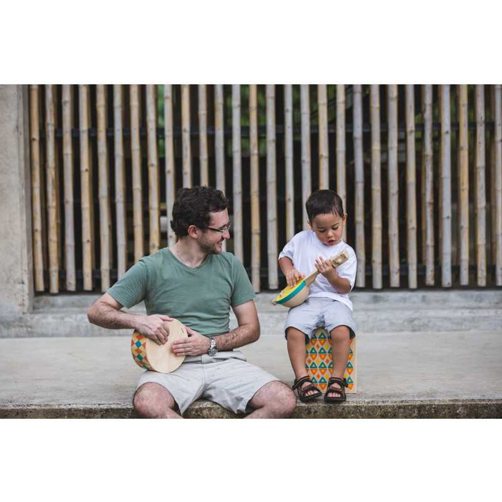 Kid playing PlanToys Banjolele