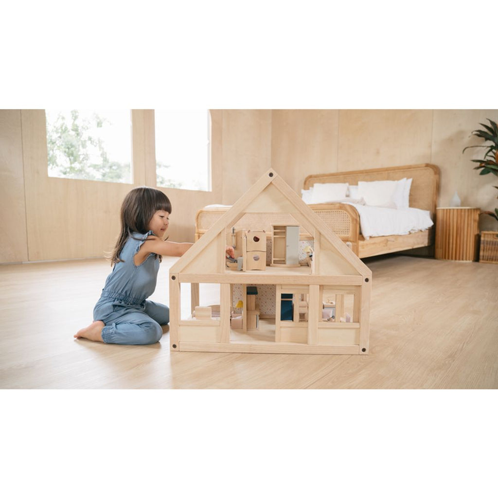 Kid playing PlanToys My First Dollhouse