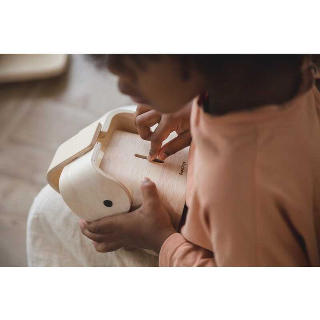 Kid using PlanToys Elephant Bank