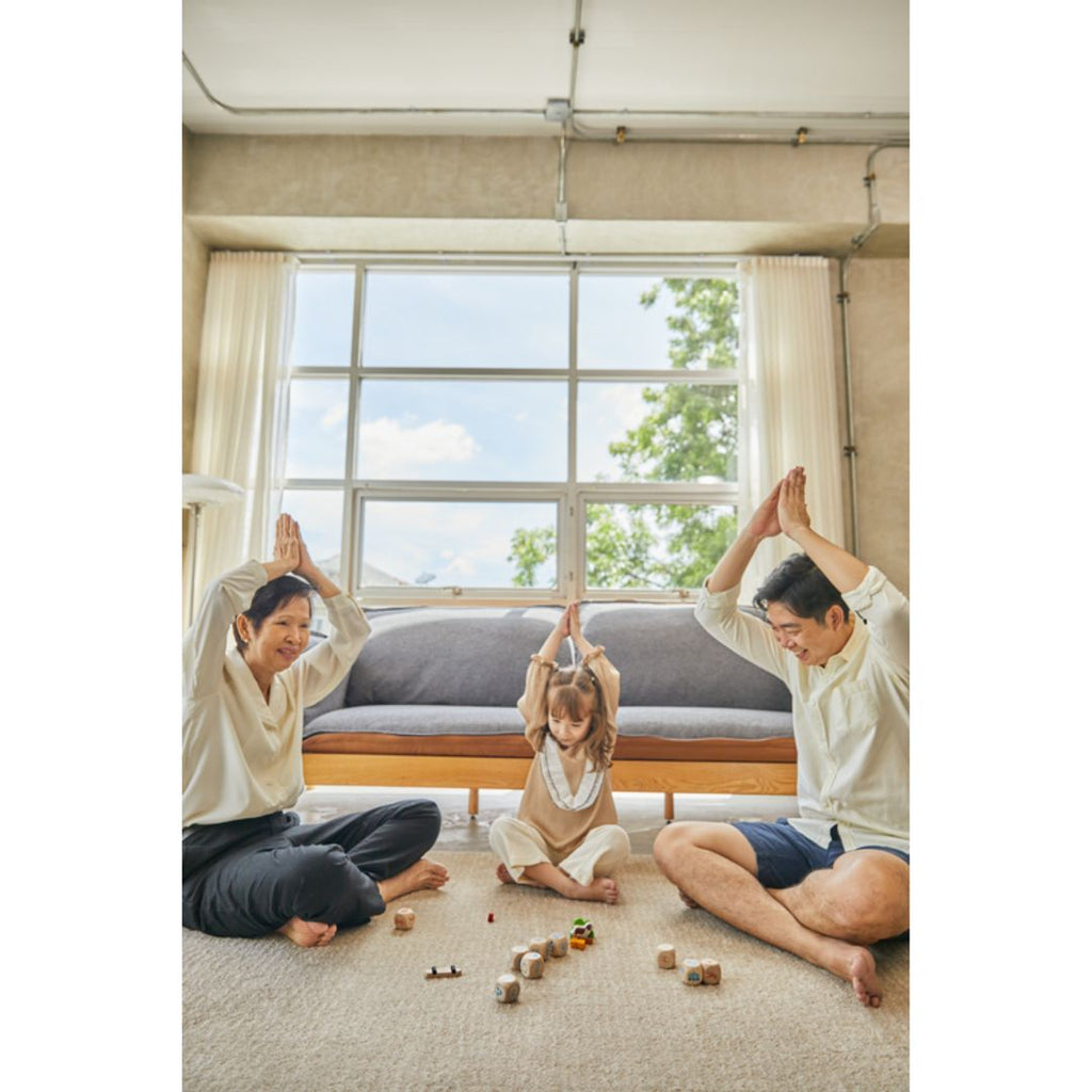 Family playing PlanToys Storytelling Dice