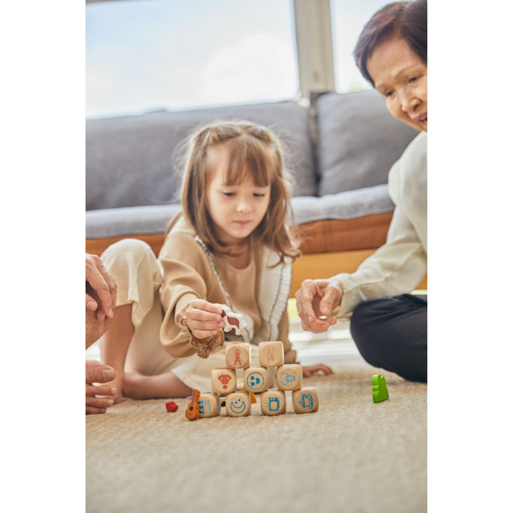 Family playing PlanToys Storytelling Dice