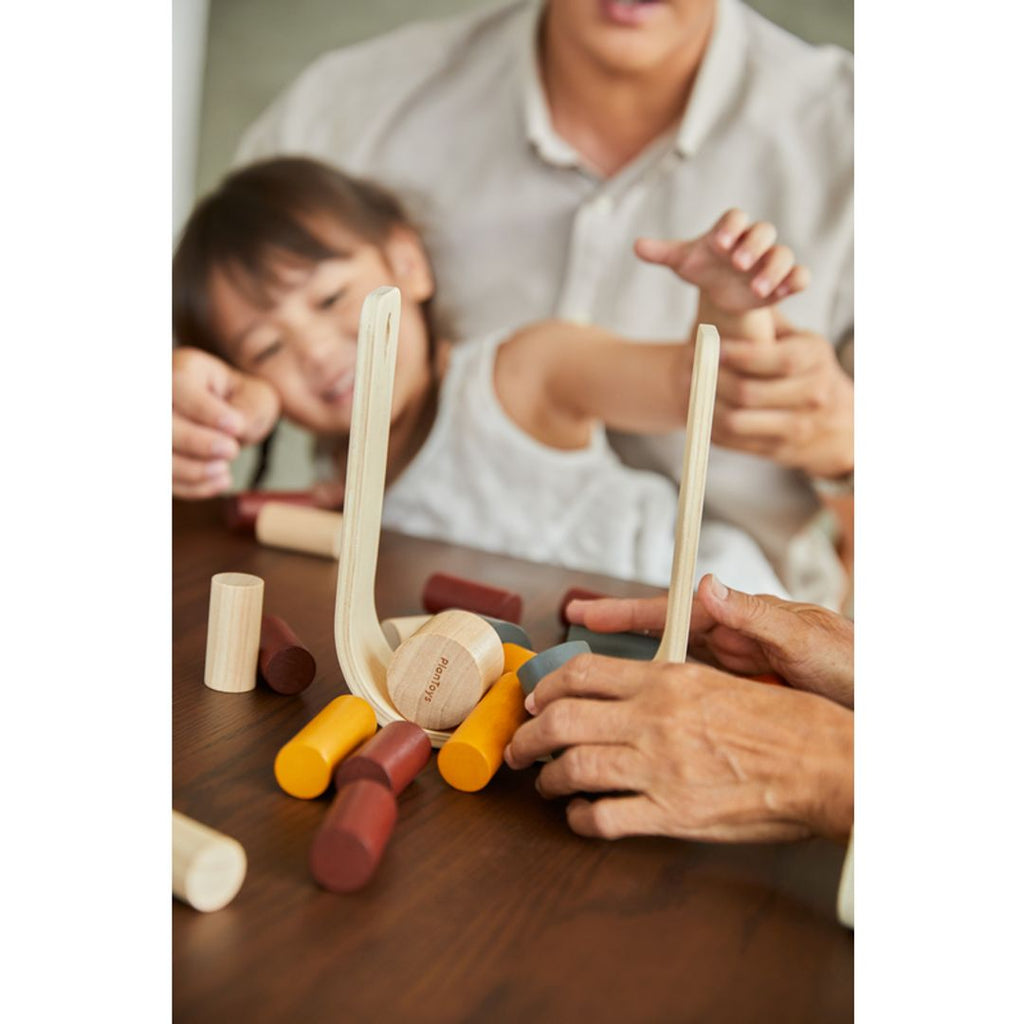 Family playing PlanToys Beaver Tumble