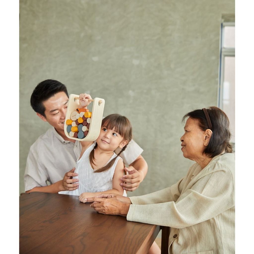 Family playing PlanToys Beaver Tumble