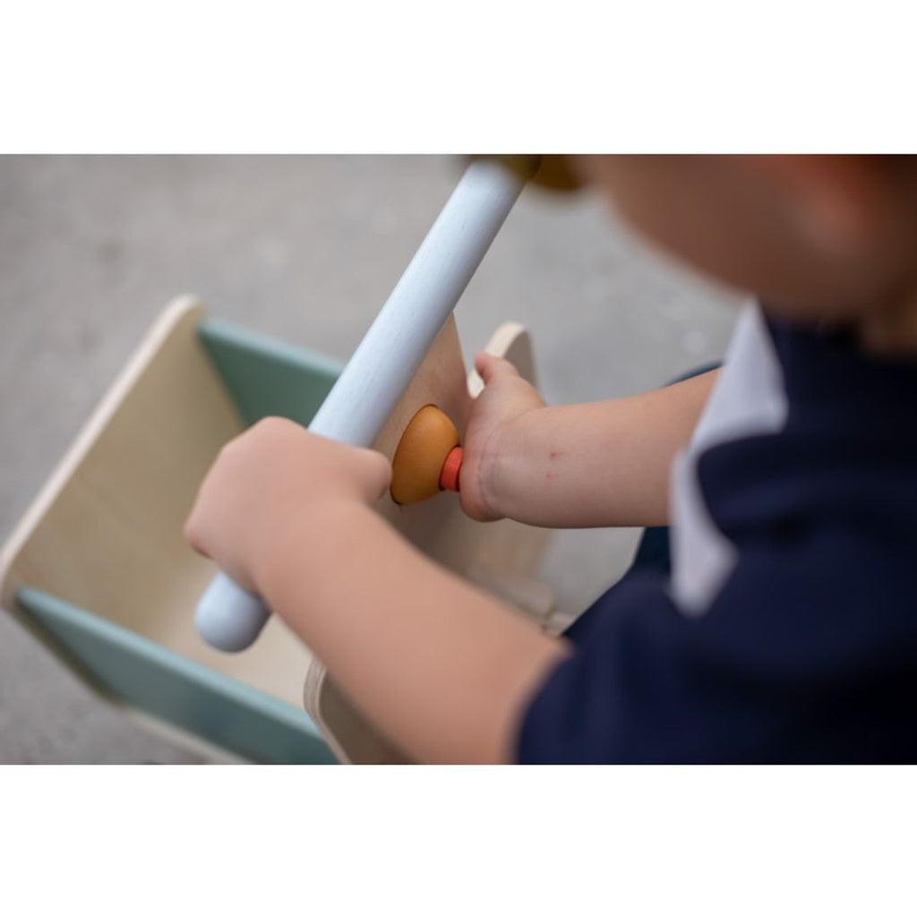 Kid playing PlanToys Delivery Bike - Orchard Collection