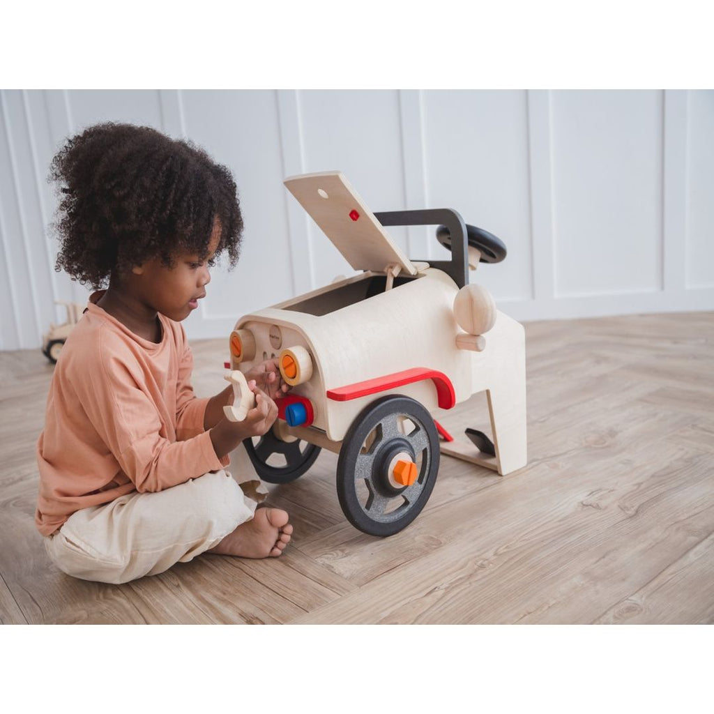 Kid playing PlanToys Motor Mechanic