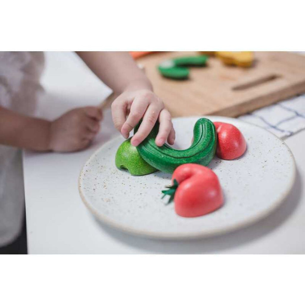 Kid playing PlanToys Wonky Fruit & Vegetables