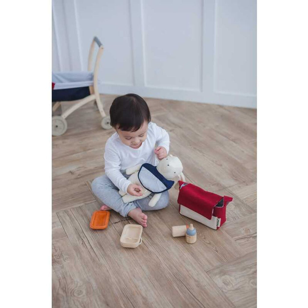 Kid playing PlanToys Doll Feeding Set