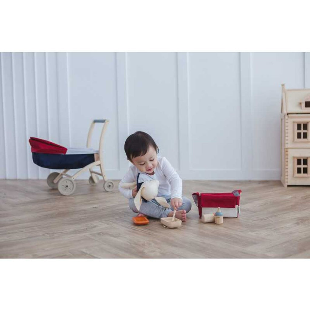 Kid playing PlanToys Doll Feeding Set