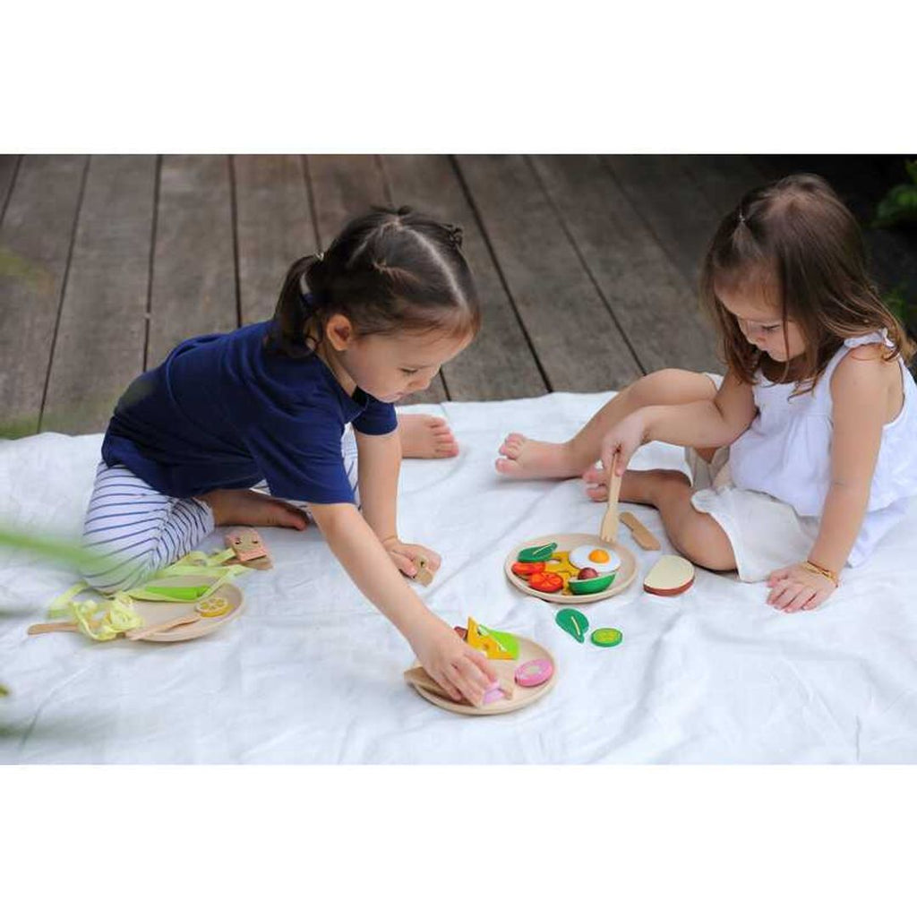 Kid playing PlanToys Breakfast Set