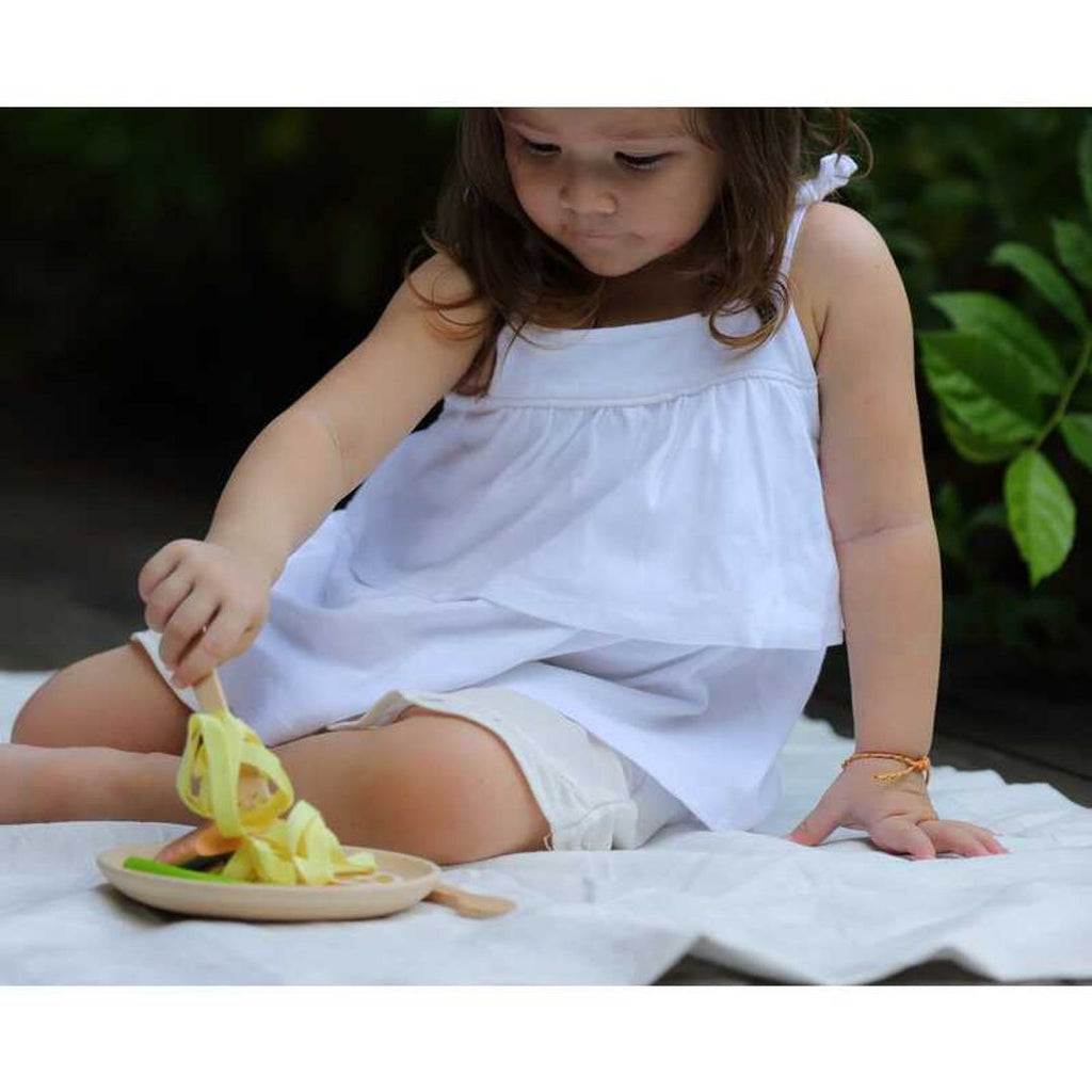 Kid playing PlanToys Pasta