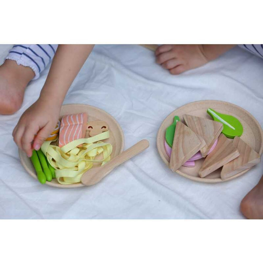 Kid playing PlanToys Pasta