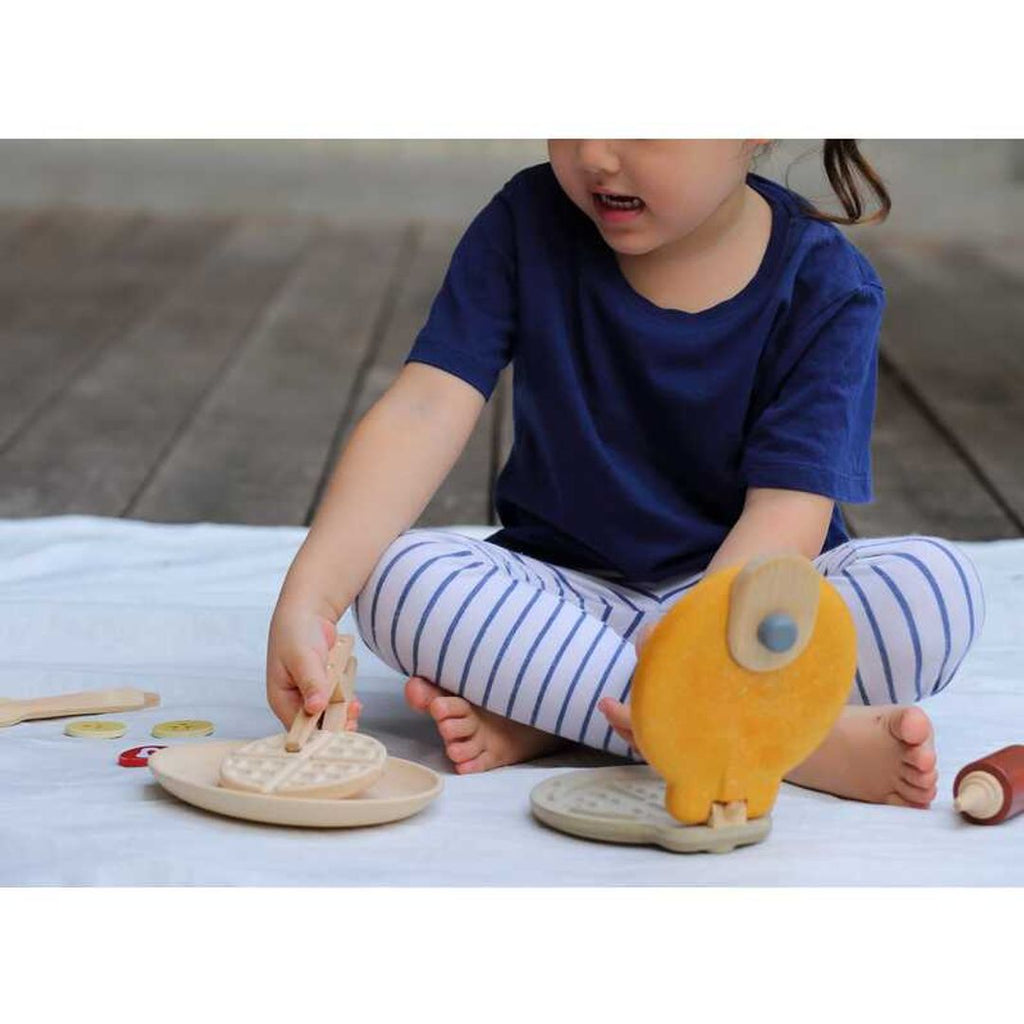 Kid playing PlanToys Waffle Set