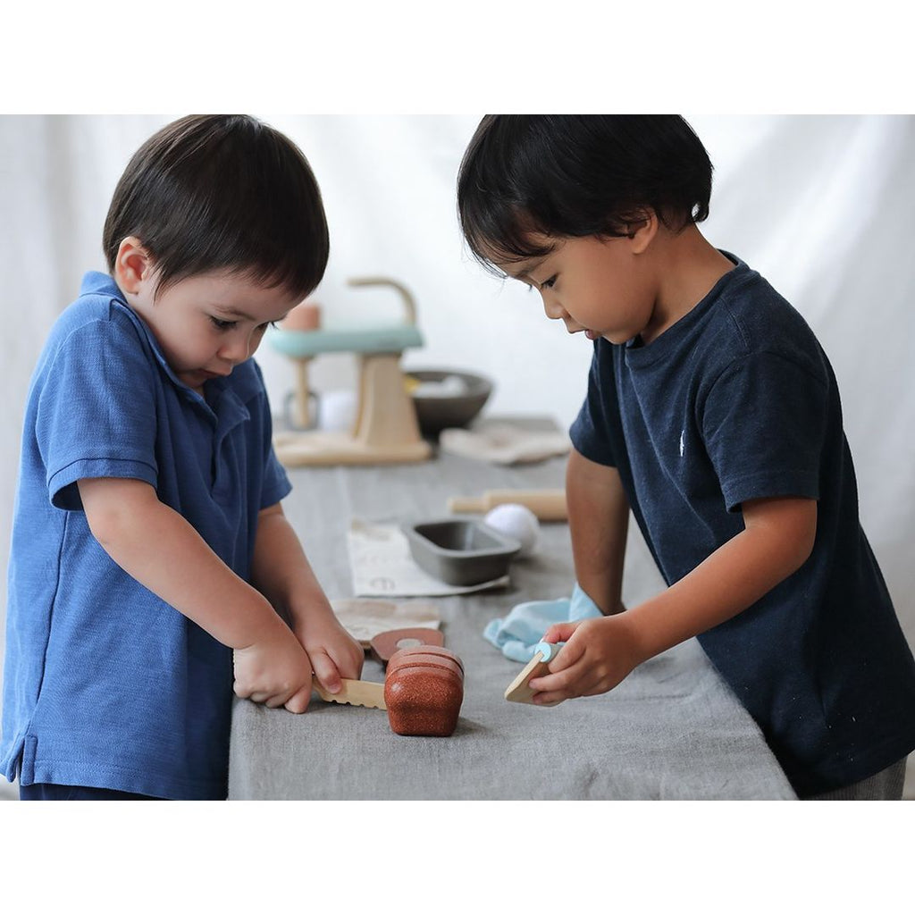 Kid playing PlanToys Bread Loaf Set