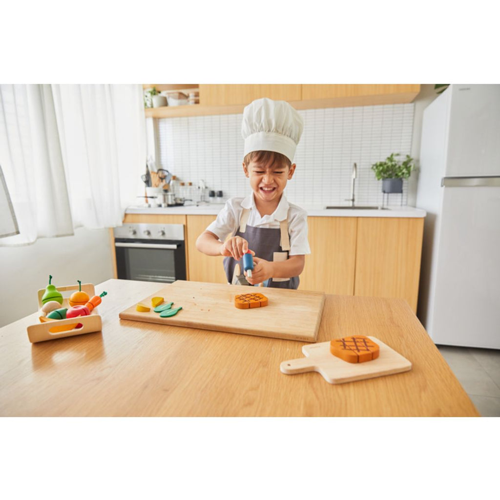 Kid playing PlanToys Chef Set