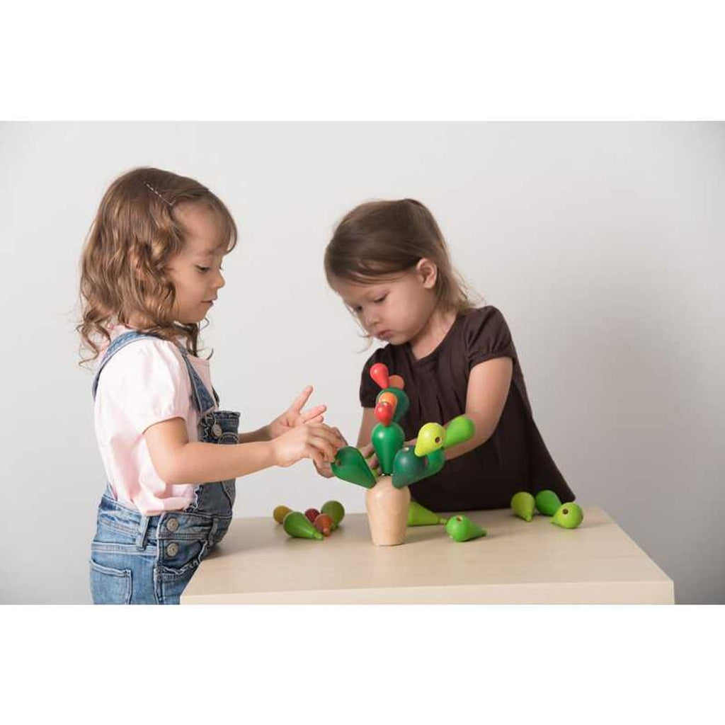 Kid playing PlanToys Balancing Cactus