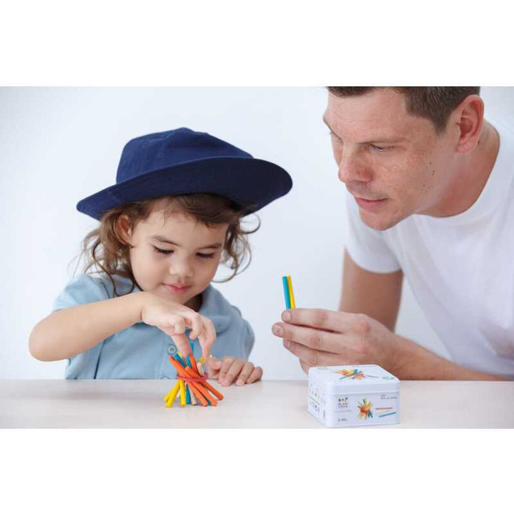 Kid playing PlanToys Pick-Up Sticks