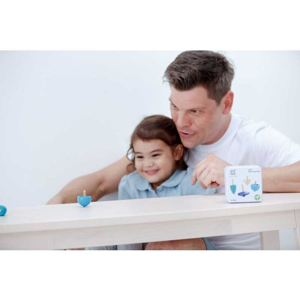 Kid playing PlanToys Spinning Tops