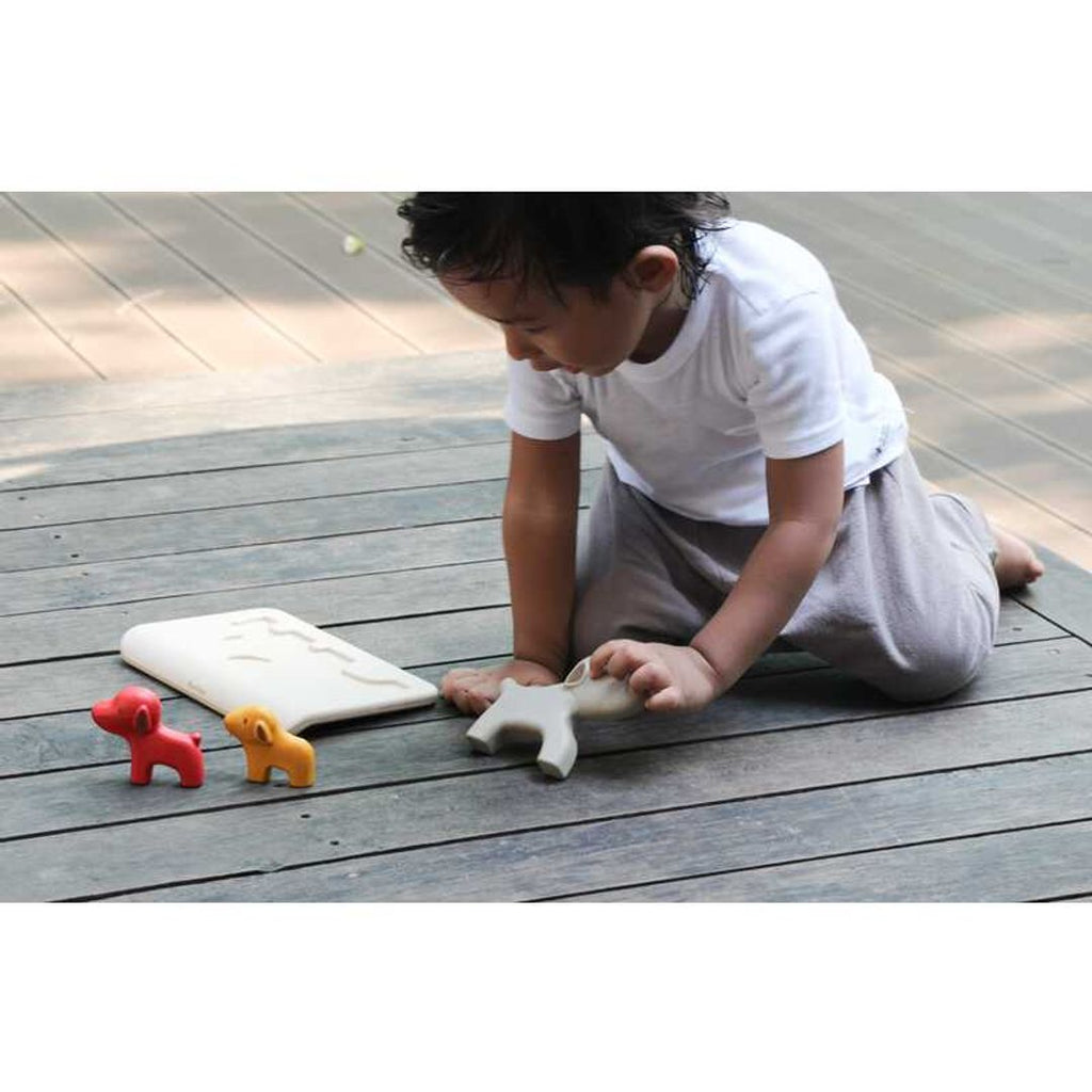 Kid playing PlanToys Dog Puzzle