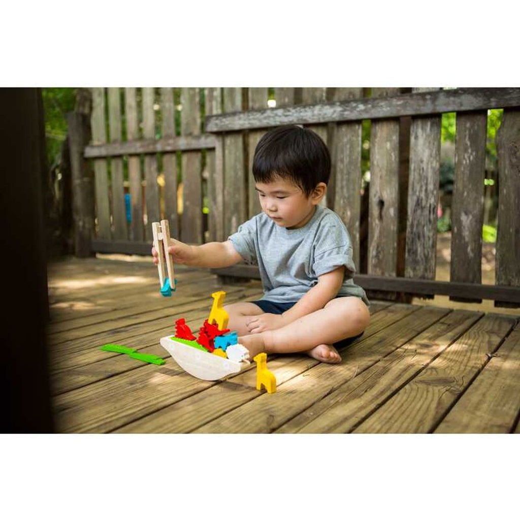 Kid playing PlanToys Balancing Boat