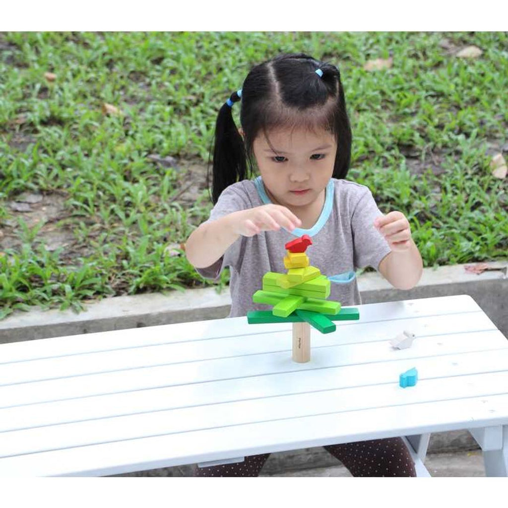 Kid playing PlanToys Balancing Tree