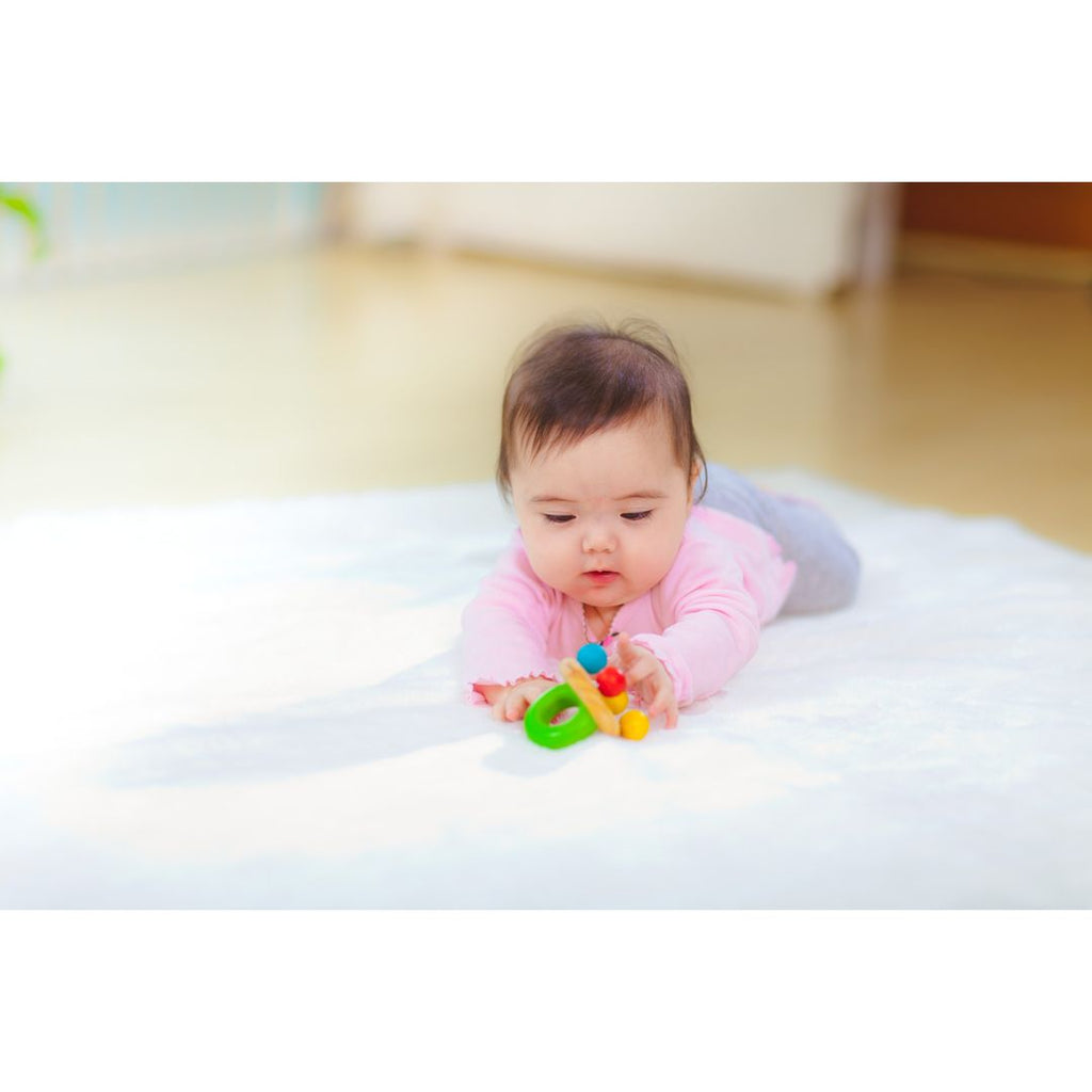 Kid playing PlanToys Bell Rattle