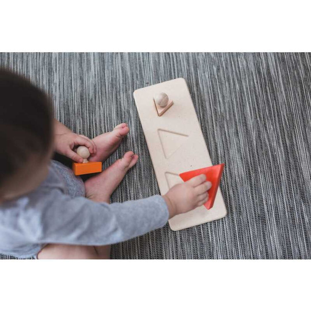 Kid playing PlanToys Triangle Matching Puzzle