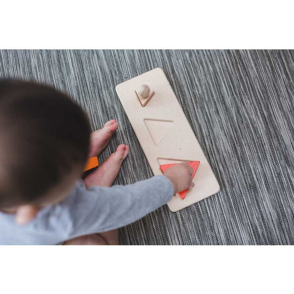 Kid playing PlanToys Triangle Matching Puzzle