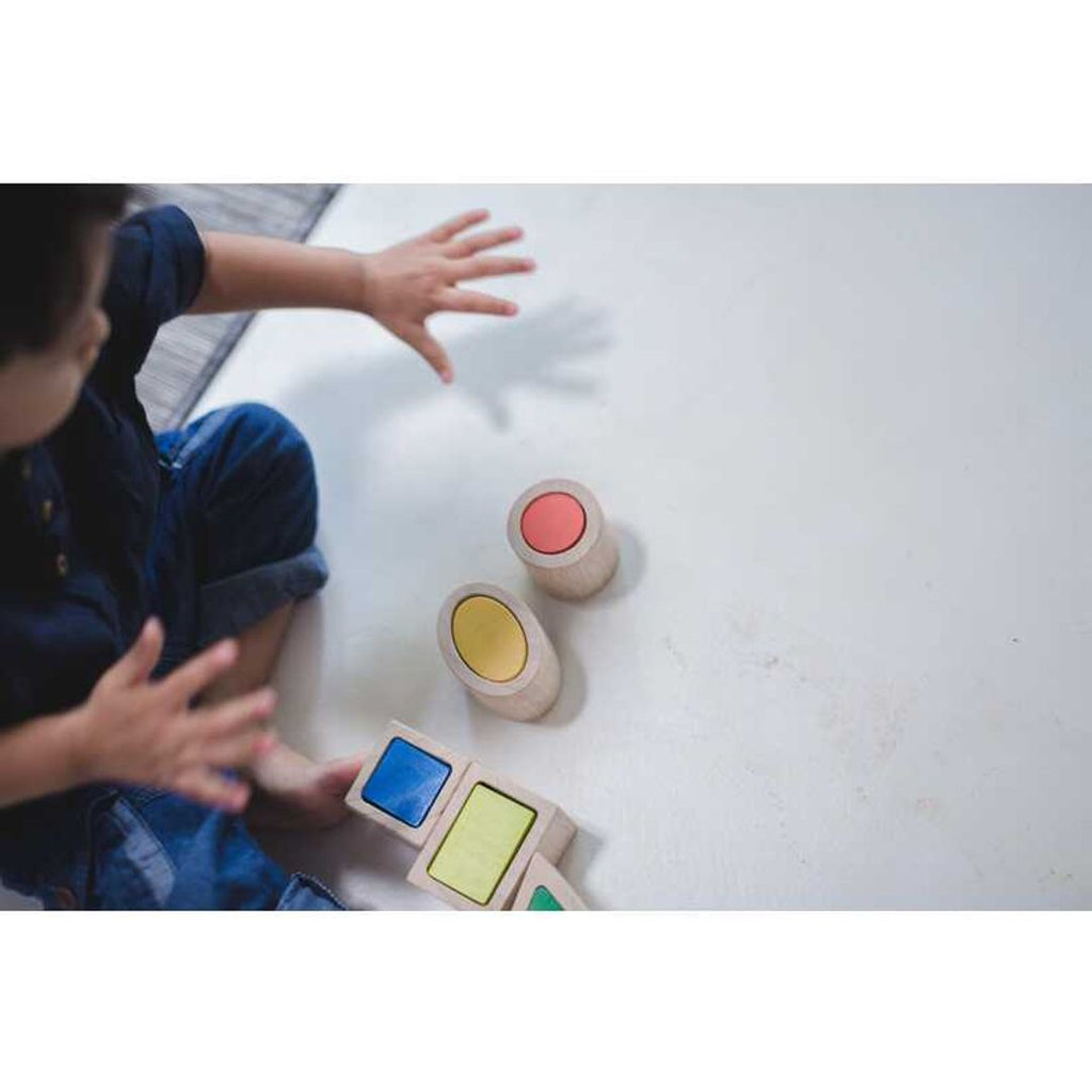 Kid playing PlanToys Geo Matching Blocks