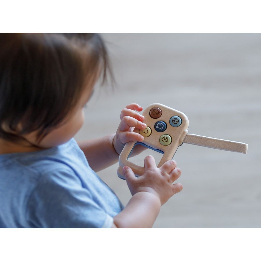 Kid playing PlanToys My First Phone - Orchard