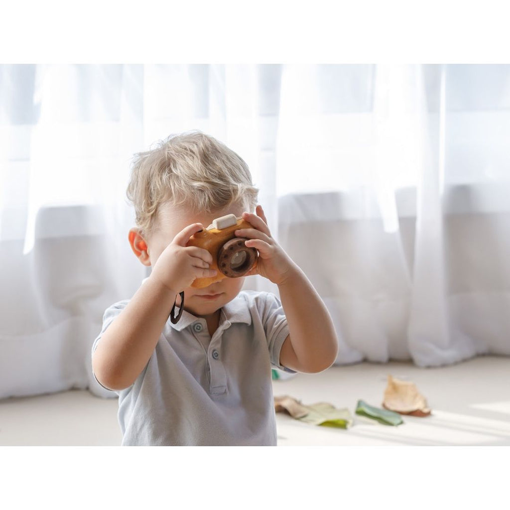 Kid playing PlanToys My First Camera - Orchard