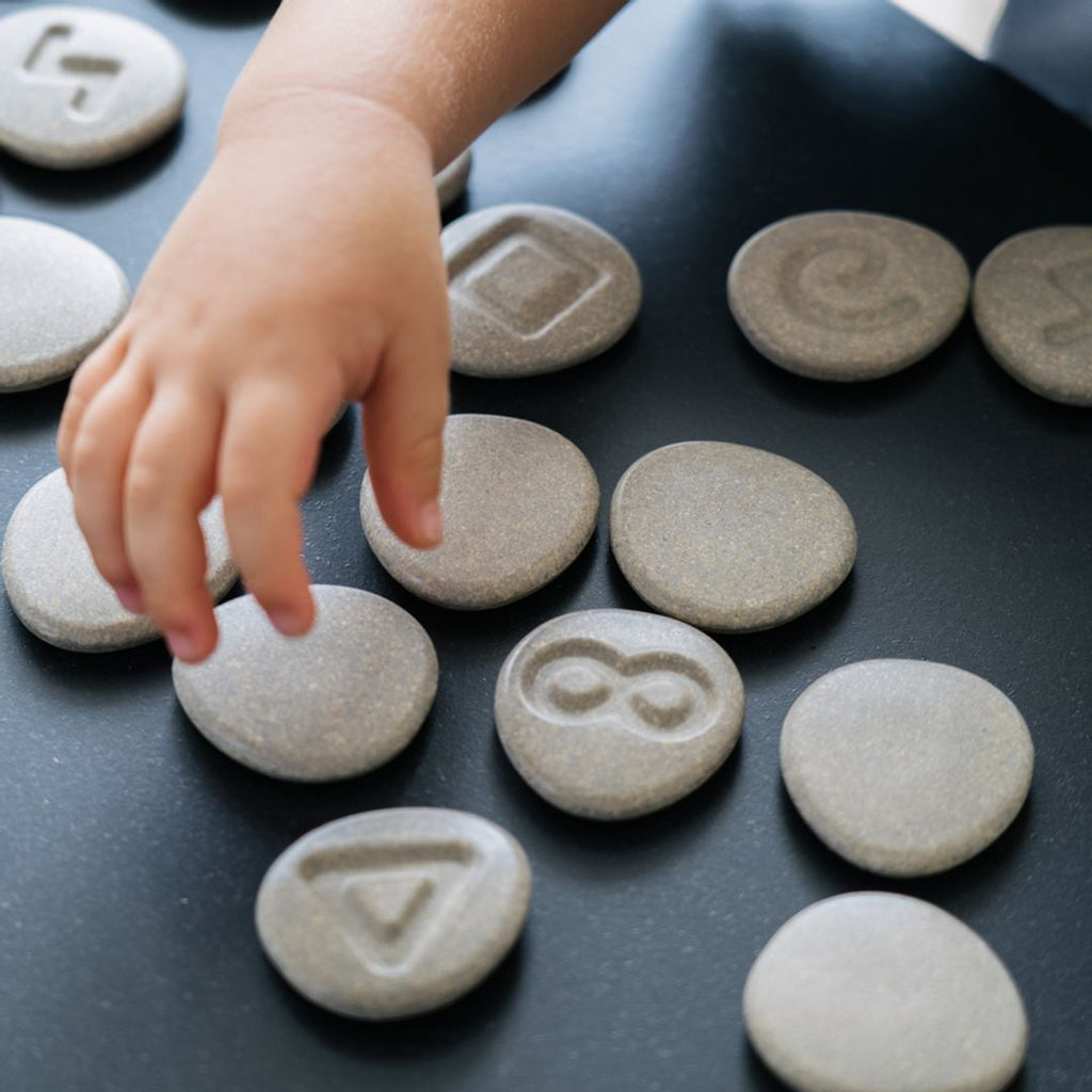 Kid playing PlanToys Tactile Stone