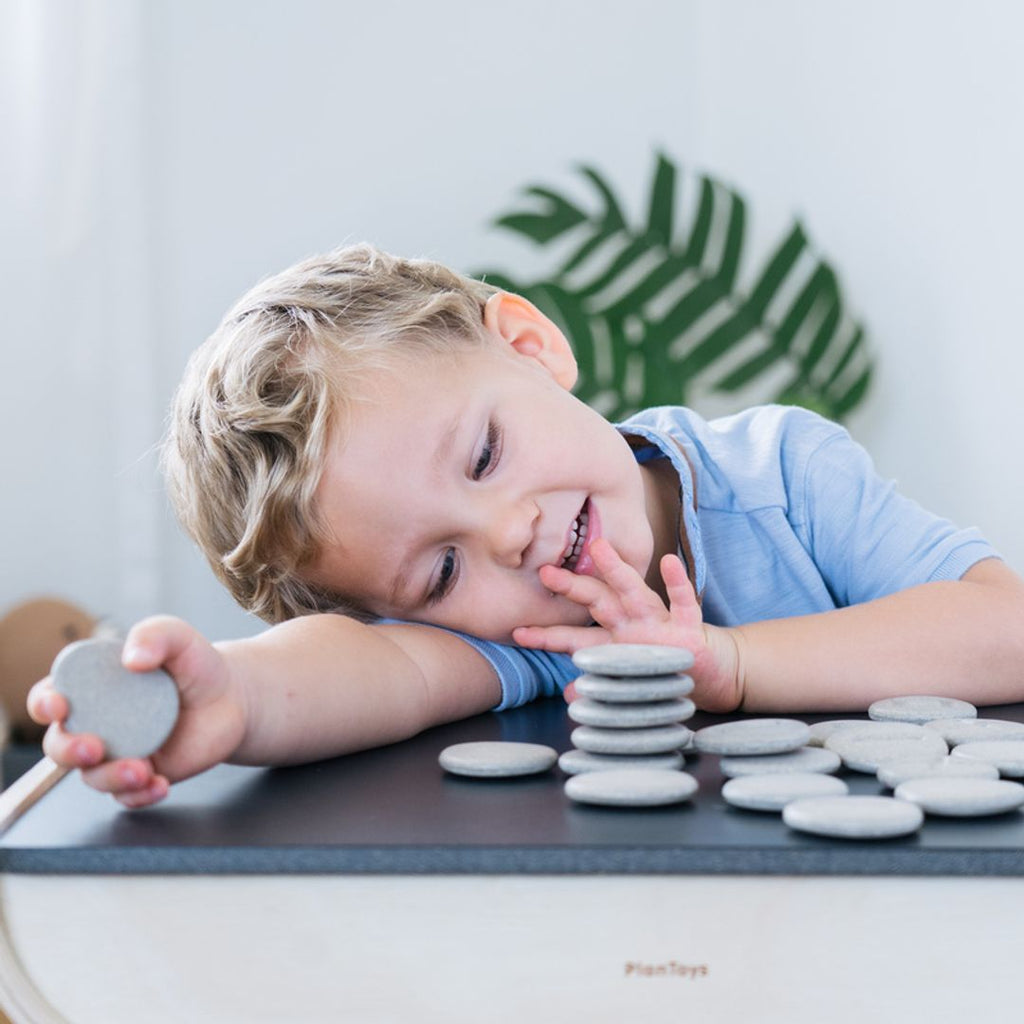 Kid playing PlanToys Tactile Stone