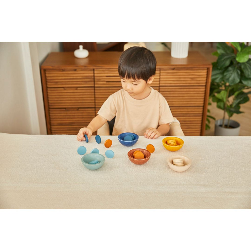 Kid playing PlanToys Sort & Count Cups - Orchard 