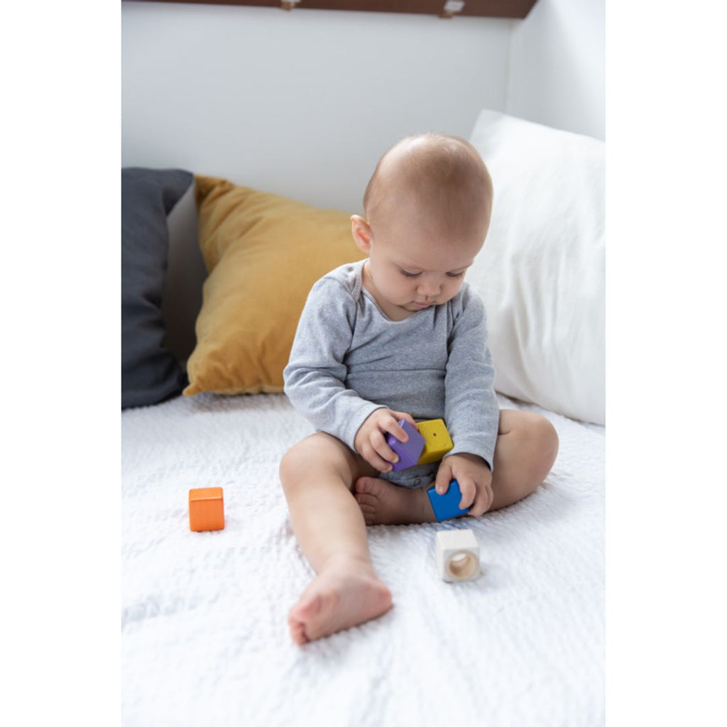 Kid playing PlanToys Activity Blocks