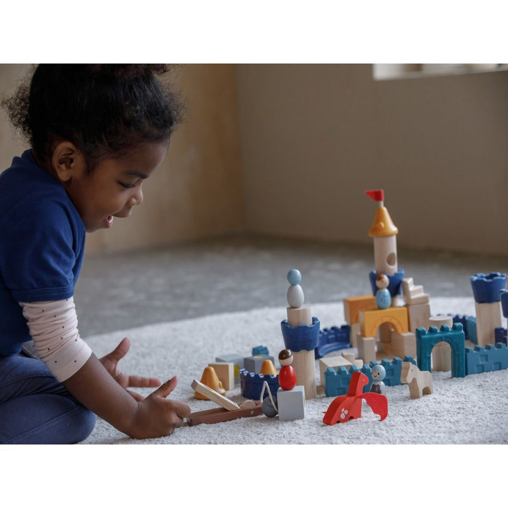 Kid playing PlanToys Castle Blocks - Orchard Series