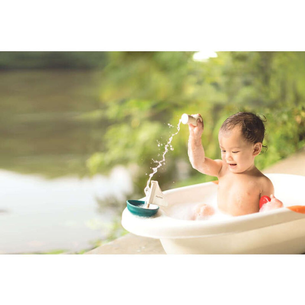 Kid playing PlanToys Sailing Boat - Polar Bear