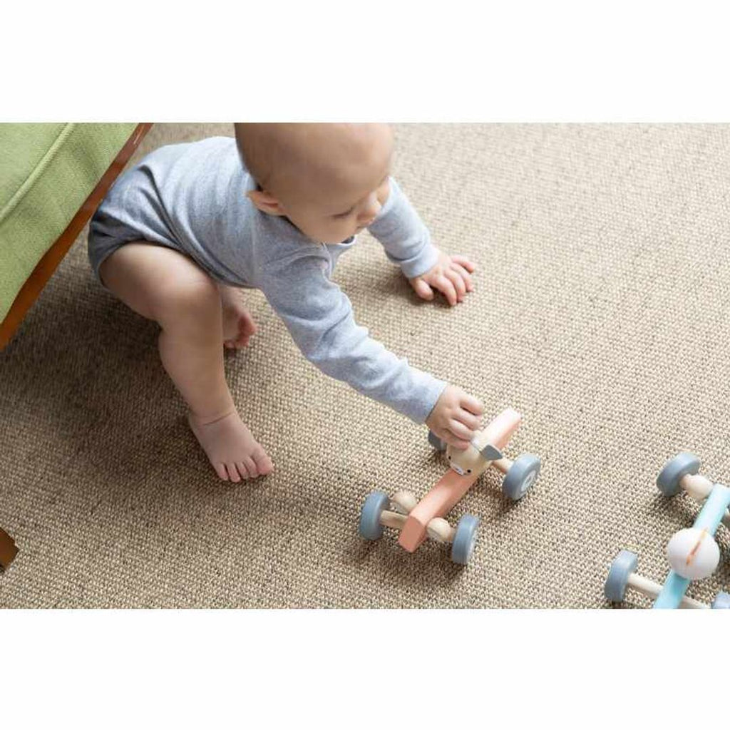 Kid playing PlanToys Chicken Racing Car