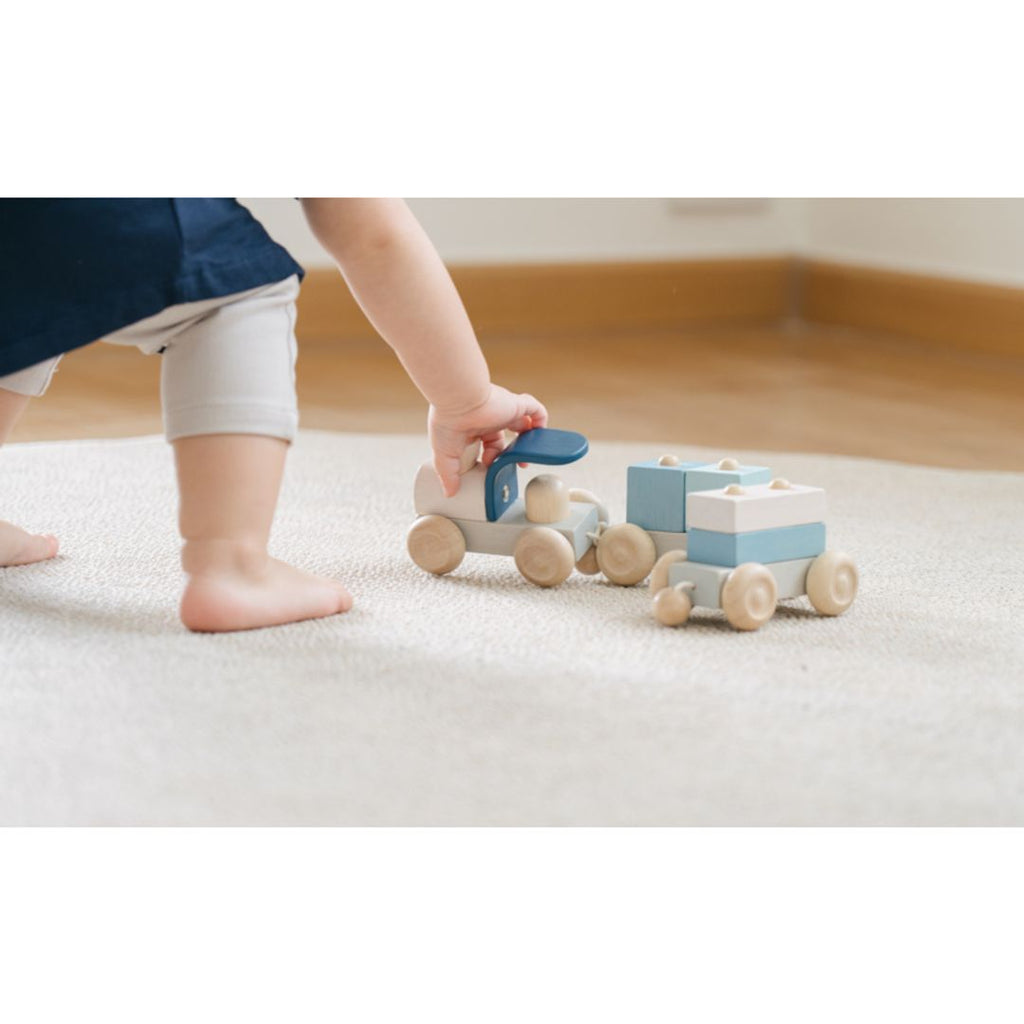 Kid playing PlanToys Stacking Train Trio - Orchard