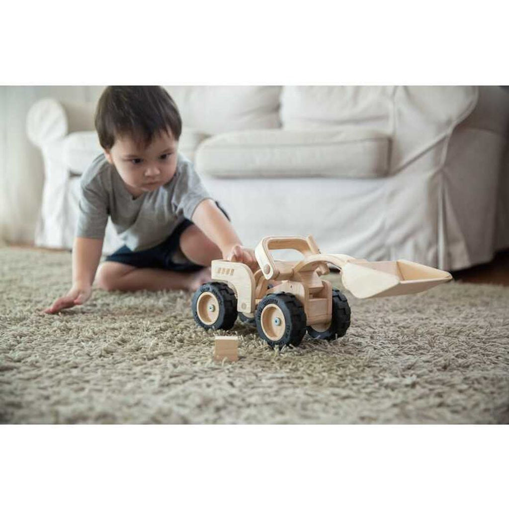 Kid playing PlanToys Bulldozer