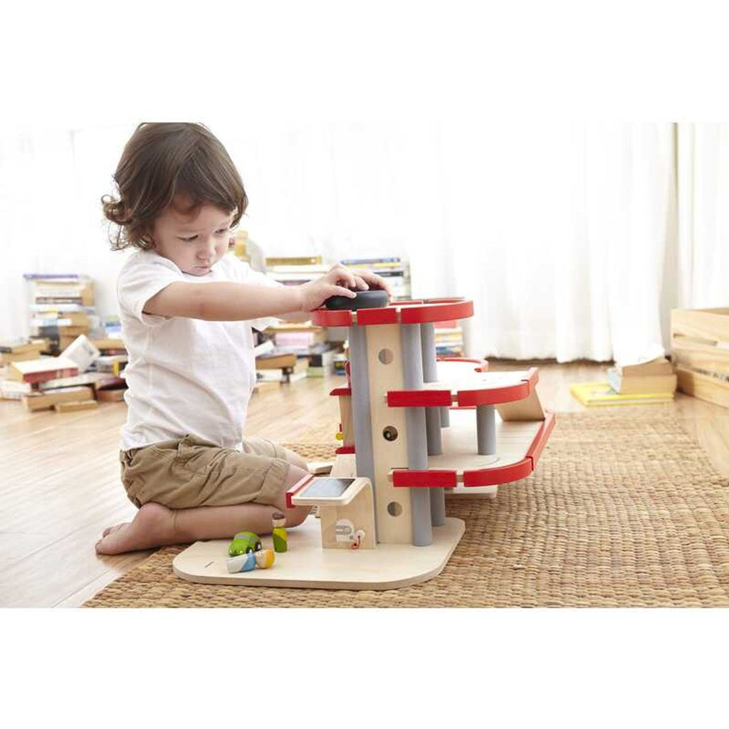 Kid playing PlanToys Parking Garage